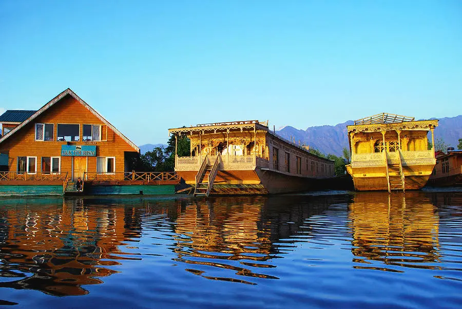 A beautiful view of the Jewels of Kashmir houseboat on the serene Nigeen Lake.